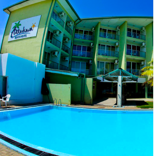 "Luxurious beachfront view at Hikkaduwa Beach Hotel in Sri Lanka, perfect for a tropical getaway." "Outdoor swimming pool at Hikkaduwa Beach Hotel, offering stunning ocean views in Sri Lanka." "Elegant room with a private balcony at Hikkaduwa Beach Hotel, ideal for a serene stay in Sri Lanka."