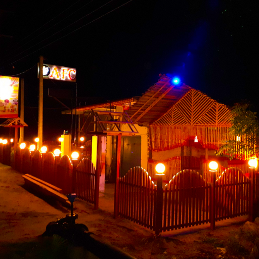 Exterior of AFC Oluvil, Sri Lanka, a lively fast-food restaurant with vibrant signage near South Eastern University. Interior of AFC Oluvil, showcasing a bustling dining area with students enjoying crispy chicken and burgers. Display counter at AFC Oluvil, featuring fresh, quality buns and popular menu items like submarines and drumsticks.